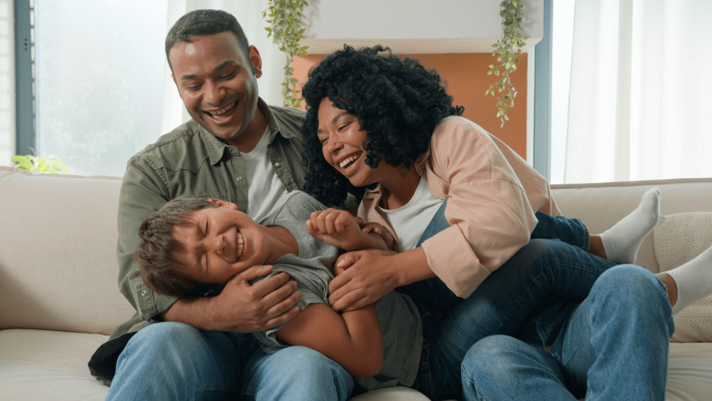 She Loves Her Stepdad—But He Presented Adult Adoption Papers Without Realizing She Still Has a Relationship with Her Bio Dad laughing child bonding with adoptive family