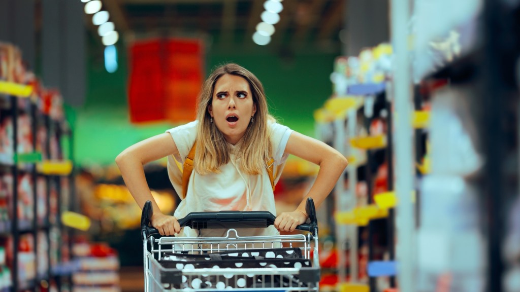 mad woman with shopping cart at supermarket