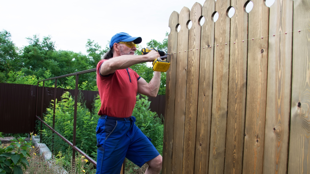 They Dug Up His Turf to Expand Their Flowerbeds—Then He Enclosed the True Property Line in 6 Foot Cedar man building a tall wooden fence