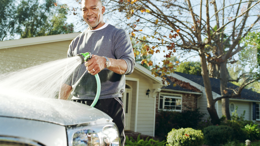 He Tried To Help A Neighbor By Lending Her A Spare Vehicle, Yet The Favor Backfired When She Began Acting Entitled To His Better Car man cleaning car in driveway