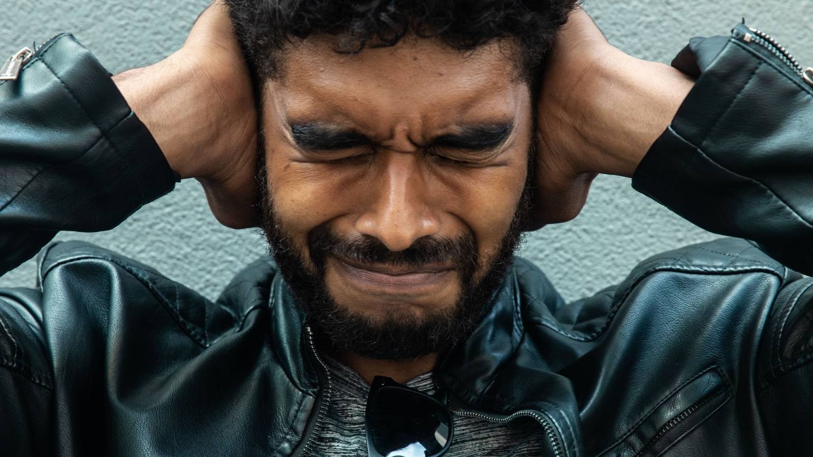 Renter Asked A Noisy New Neighbor To Simply Close Their Door, But The Excessive Noise Was Already Plaguing The Building man covering his ears