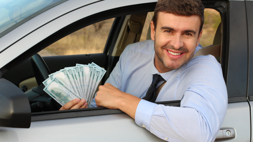 man holding $100 bills