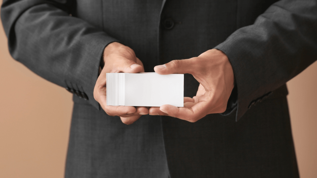 Man Thought Using Other Employees Business Cards Would Boost His Commissions, But It Quickly Backfired At Work man holding business cards