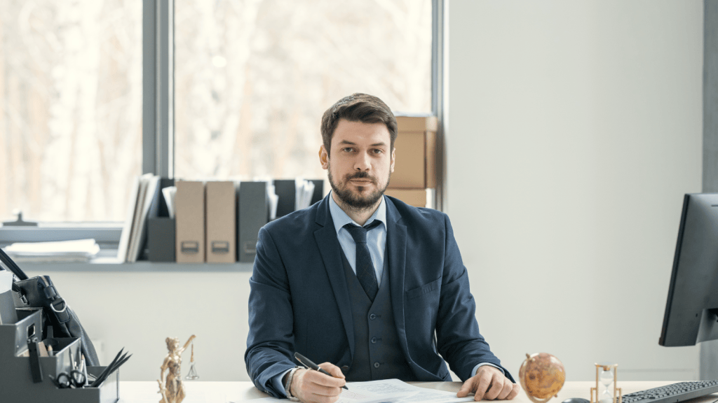 man in suit sitting at desk