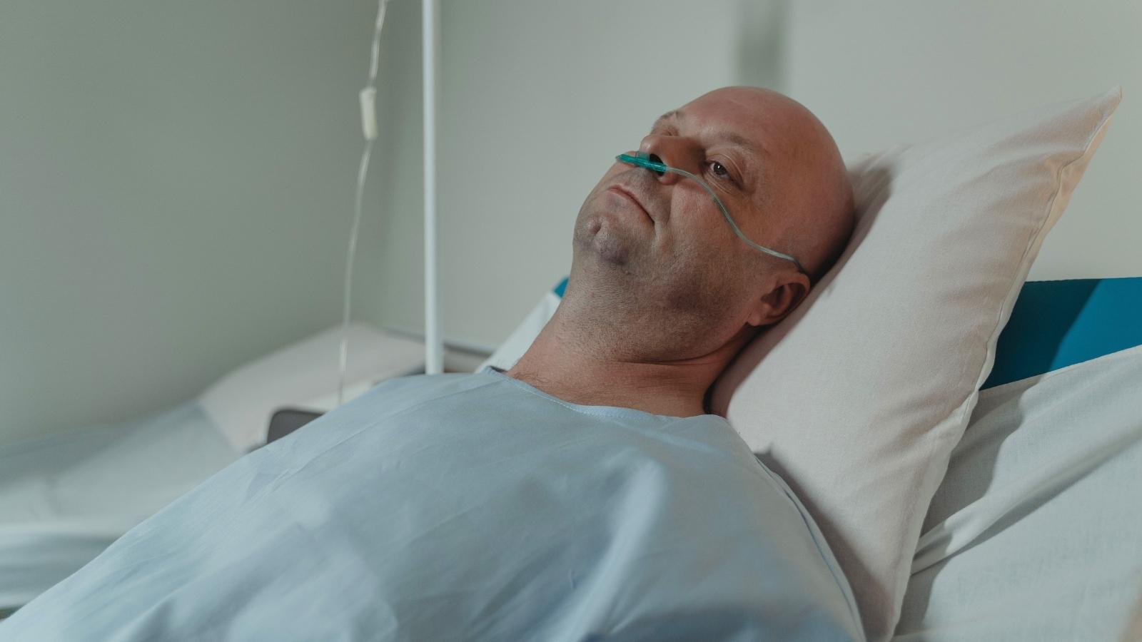 man laying in hospital bed