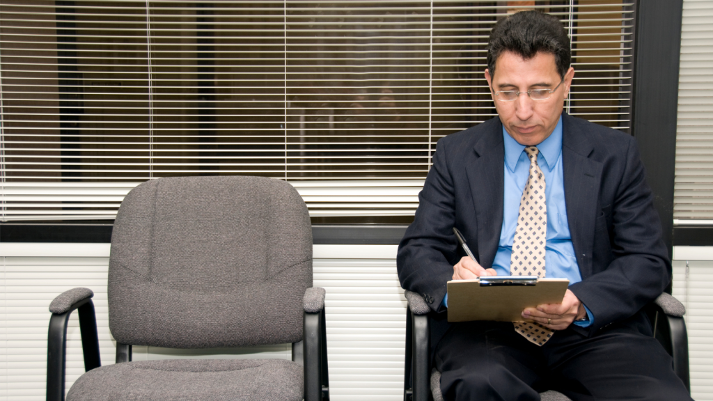 They Agreed To Help Him Digitize His Application, Yet The Simple Favor Revealed Multiple Errors He Had Apparently Missed man proofreading document in chair