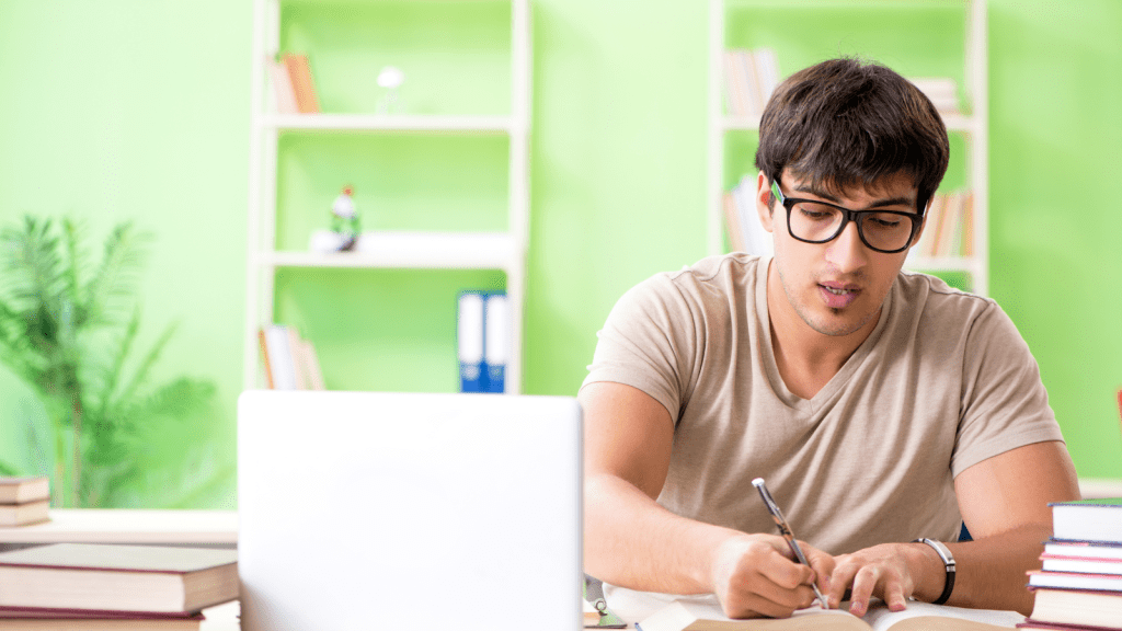He Thinks Studying 14 Hours a Day Is His Right—Now His Parents Are Threatening to Pull Him Out of College to Save Him From Himself man studying in front of a desk focused on books and computers