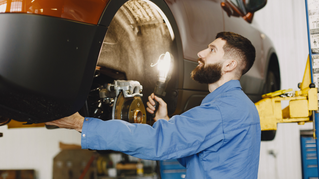 They Paid $1,200 for a Transmission Service—Then the Shop Locked the Bay and Demanded an Extra $800 for Unapproved Tear Down Labor mechanic working on a car