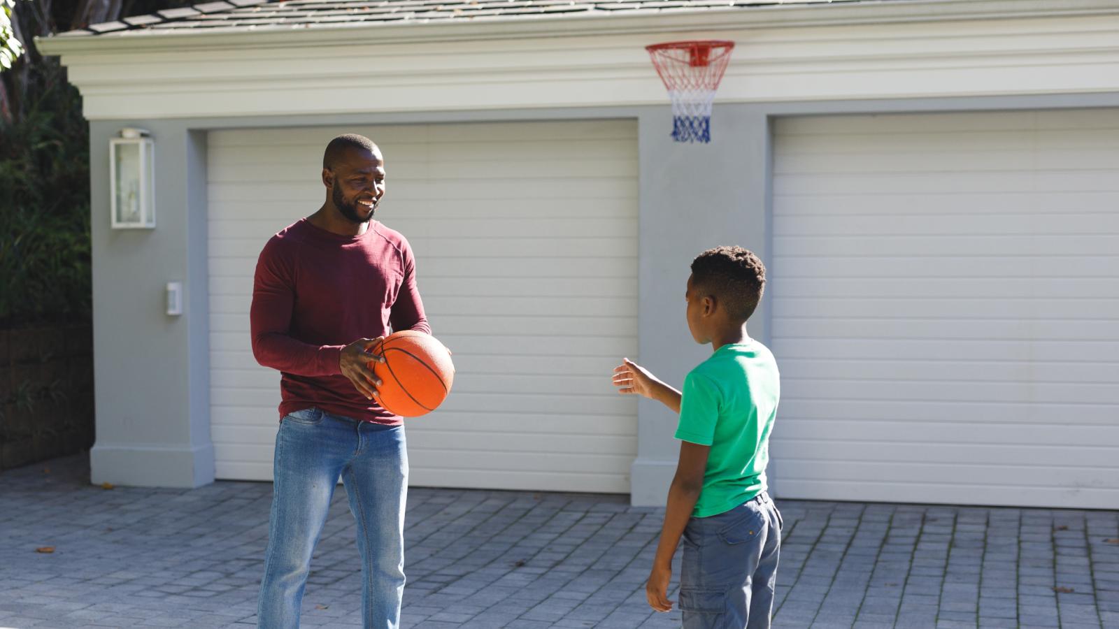 His Neighbors Complained About His New Backyard Basketball Hoop — So Hes Filing a Complaint About Their Barking Dogs man playing basketball with his son