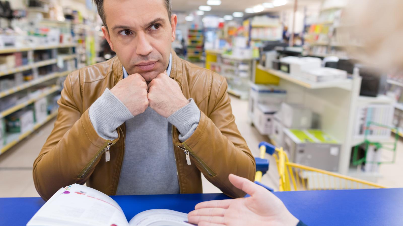 An Entitled Customer Demanded a Spontaneous 30% Off Just for Being a Regular—So the Worker Politely Handed Him the Stores Formal Discount Policy Pamphlet man talking to a worker in a store