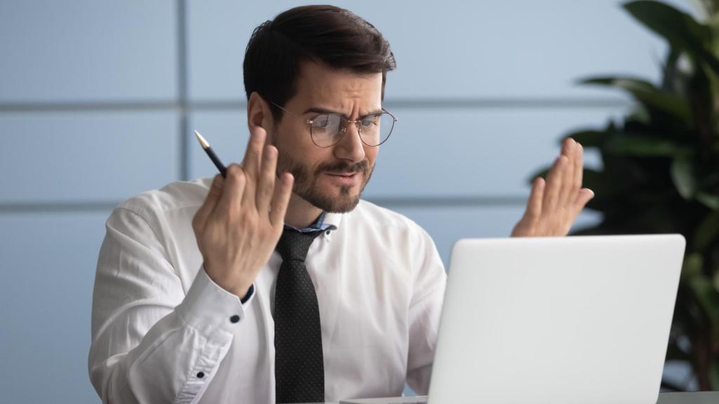 man looking at his computer