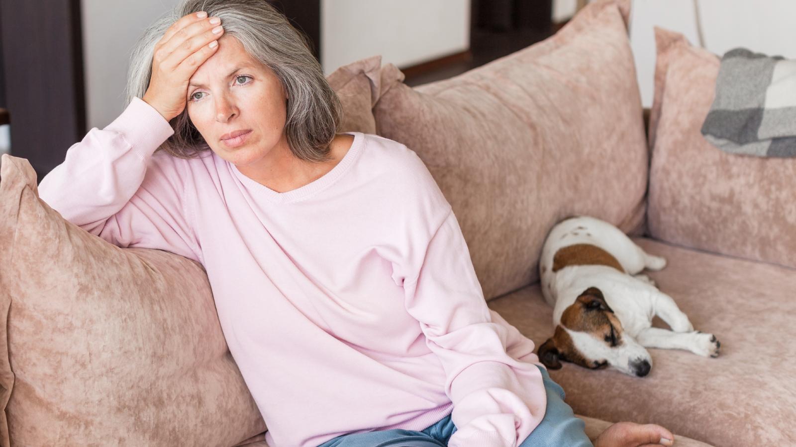 woman on a couch with a dog