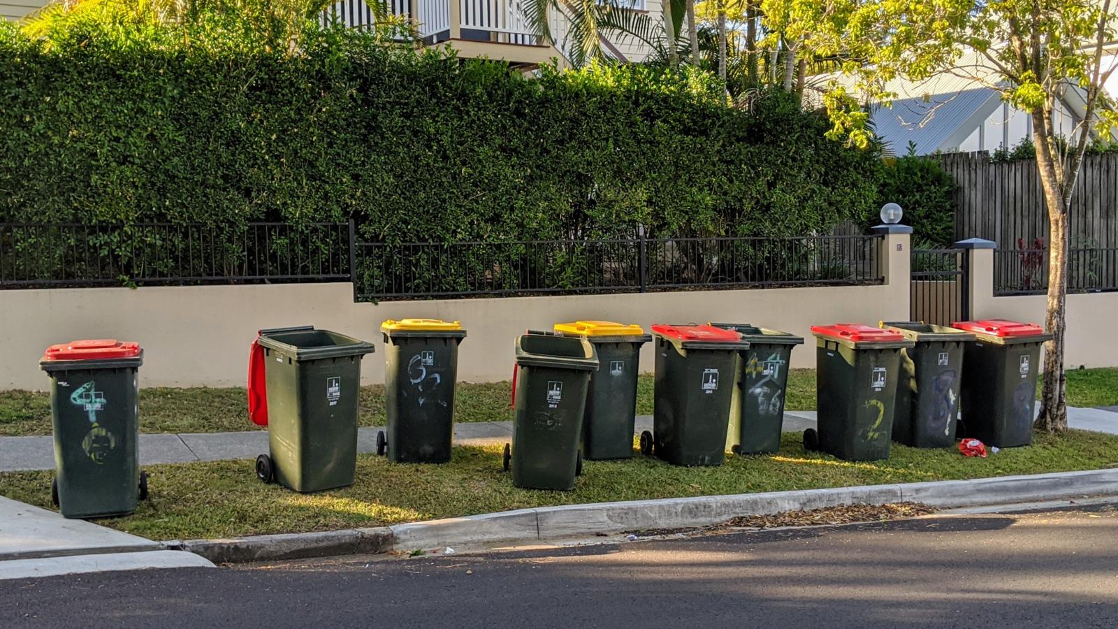 His Neighbors Keep Leaving Their Trash Cans in Front of His House — For Days After Pickup trash cans on a street