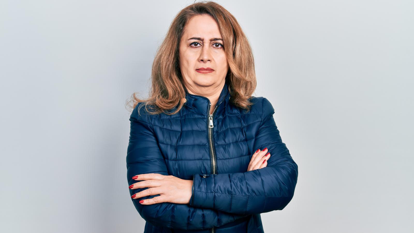 She Caught Her Neighbor Interrogating Her Contractors About Her Home Project Costs—Then Served a Formal Cease and Desist for Trespassing woman with a serious expression