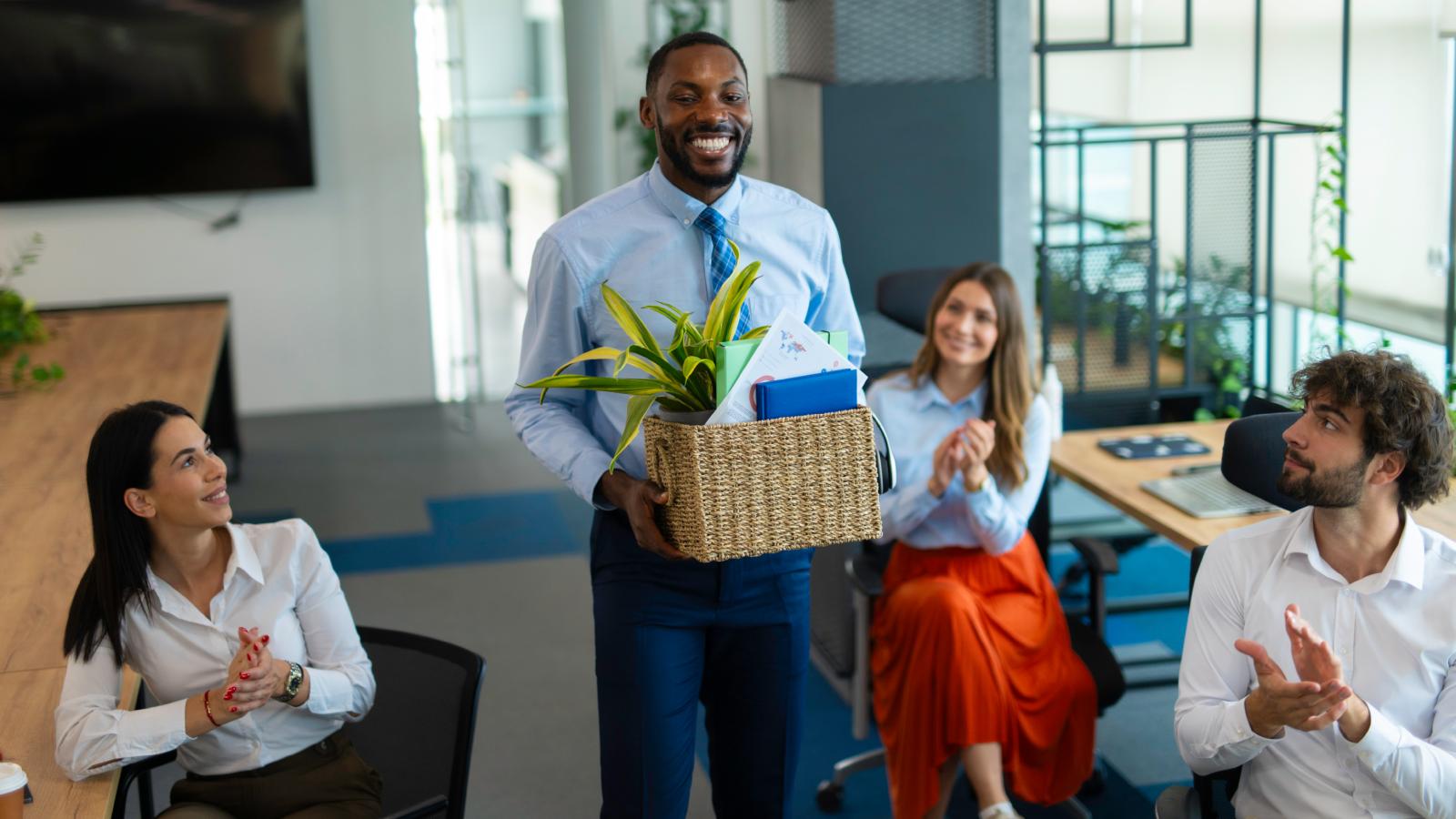 man carrying a box in an office