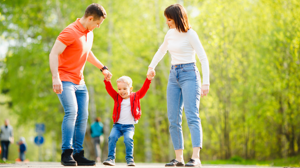 One Family’s Godparent Request Becomes Deeply Complicated When A Woman Realizes The Child In Question May Eventually Be Her Own Brother parents holding smiling little boy's hand