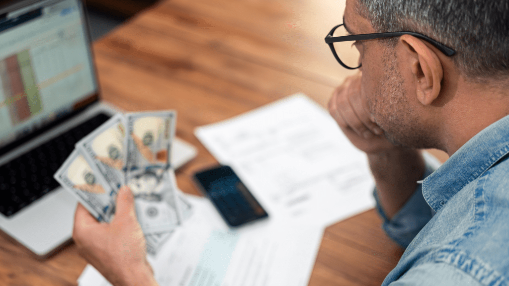 She Funded Their Vacations and Upgrades for Years—Then She Shut Down the Family Bank Account and Sent an Itemized Ledger person counting and budgeting bills