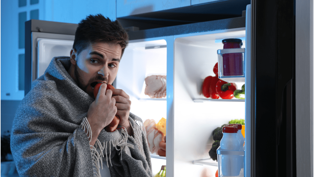 person opening refrigerator at night