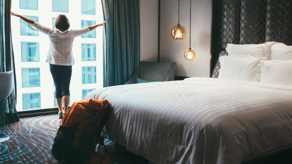 He Planned a 10 Day Family Vacation in His Sibling’s 1 Bedroom Tokyo Apartment—Then Received a List of Local Hotel Recommendations person opening up a room to a hotel