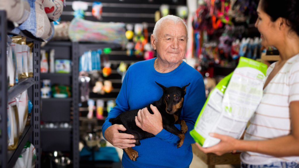 pet store interaction with man holding dog