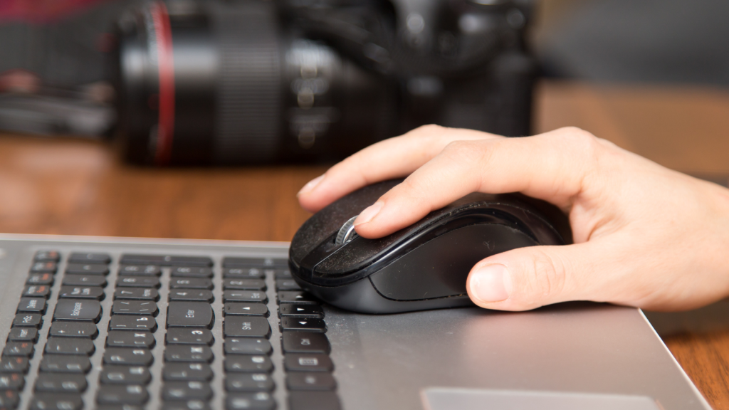 He Just Wanted a Cheap Mouse to Work Faster — Management Turned It Into a Formal Approval Process photographer working with computer mouse on top of laptop