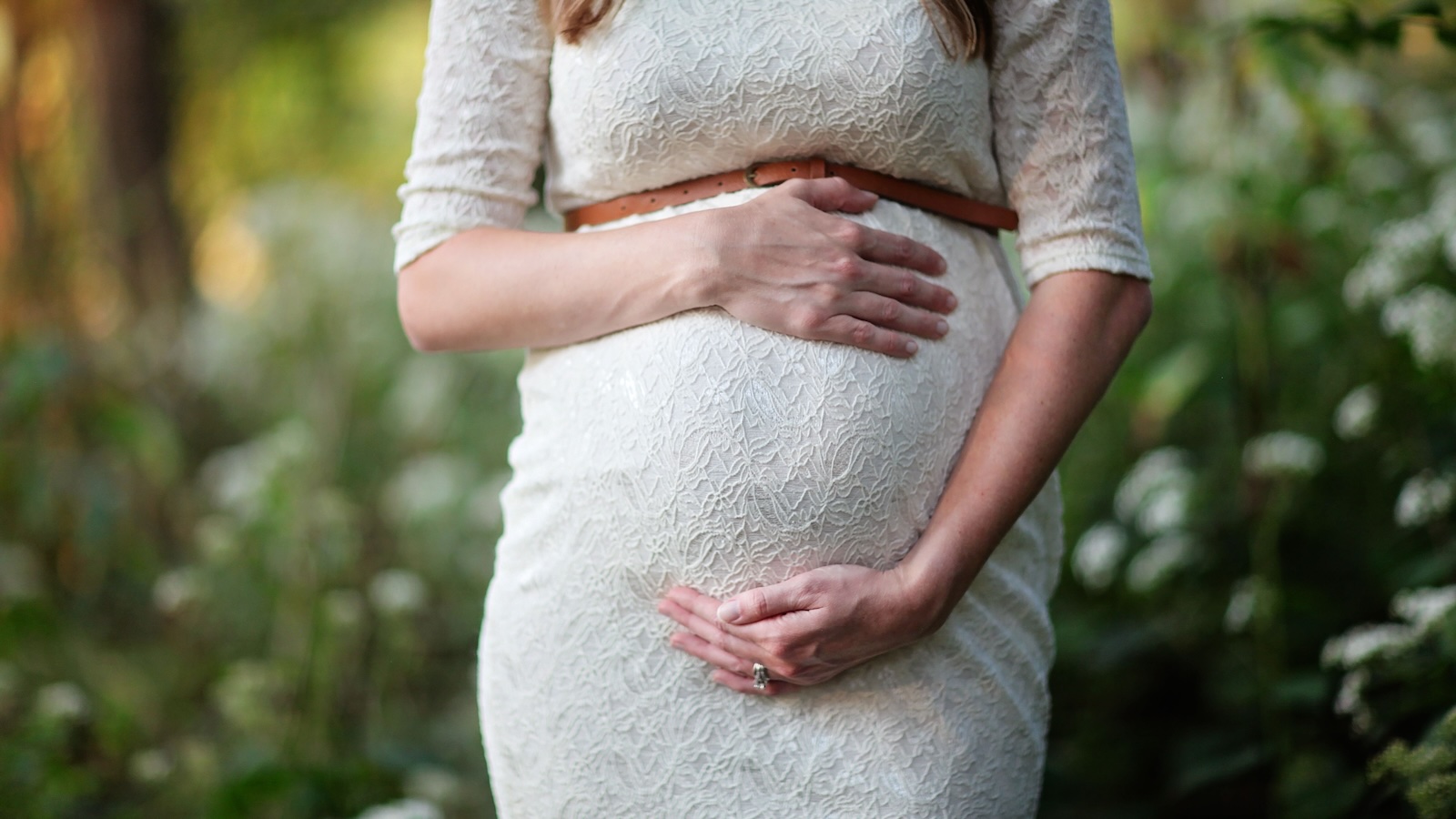 woman holding pregnant belly
