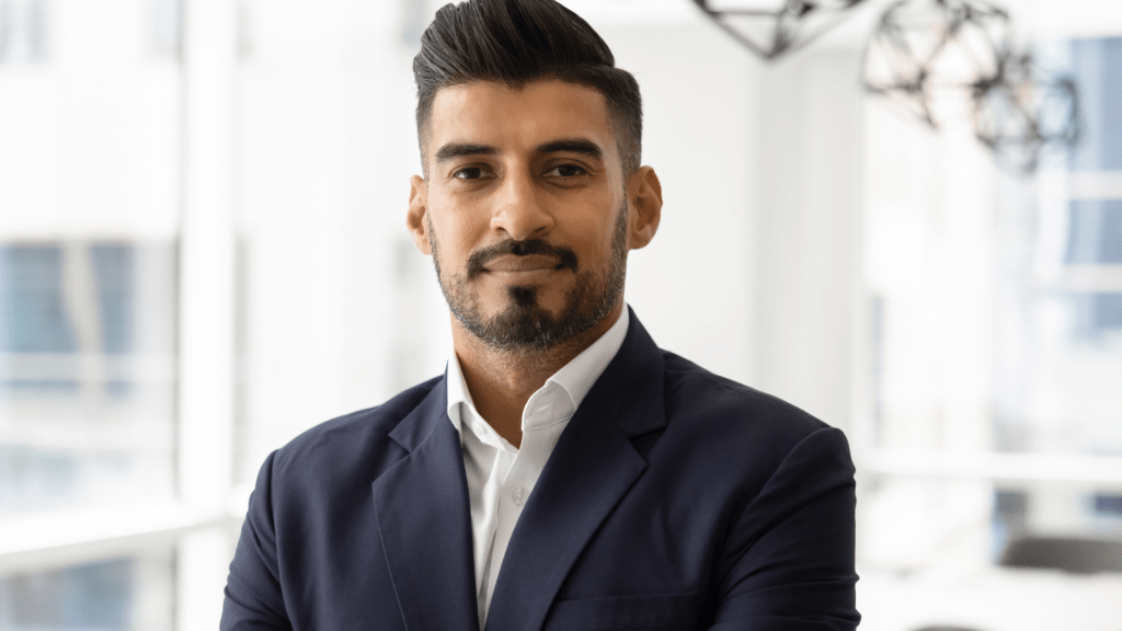 professional indian man smiling folding arms