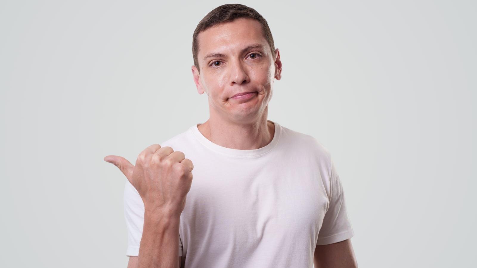 puzzled man sticking his thumb out