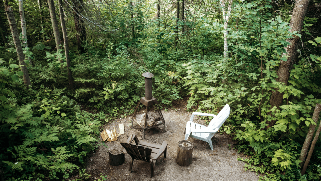 His Duplex Neighbor Wants to Add a Fire Pit to Their Shared Space—But He Says No rustic backyard fire pit with log stools