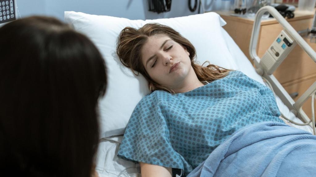 sick woman laying in a hospital bed