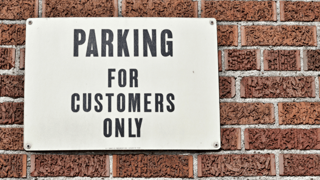 A Stranger Accused Her Of Not Belonging In A Parking Lot, And She Had To Defend Herself On The Spot sign that reads customer parking only