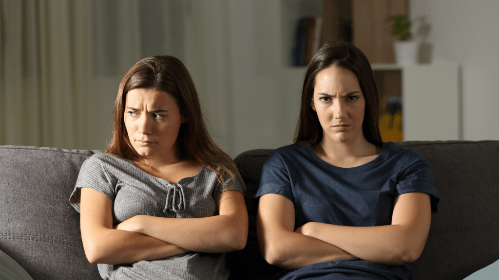 Woman Inherited Money Alongside Her Sister, But Now Her Sibling Wants The Entire Amount To Cover Her Husband’s Medical Bills sisters arguing on couch