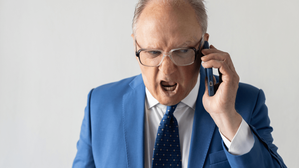 smug old man sales manager on phone