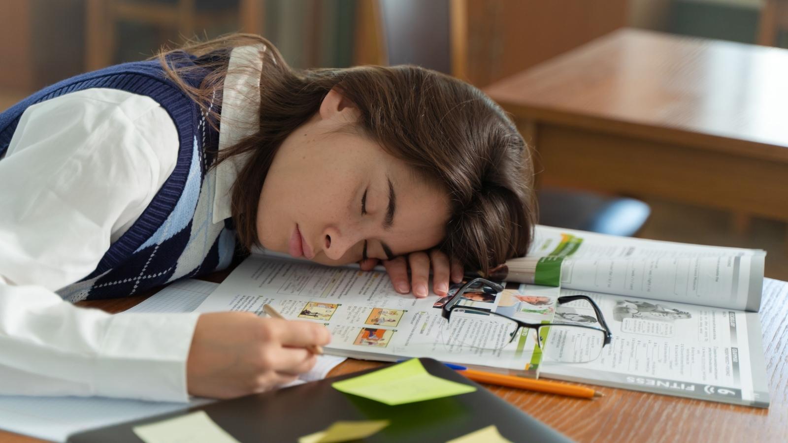 She Wanted To Leave The College She Promised To Attend With Her Best Friend — Guilt Is Keeping Her Stuck stressed college student sleeping on her books