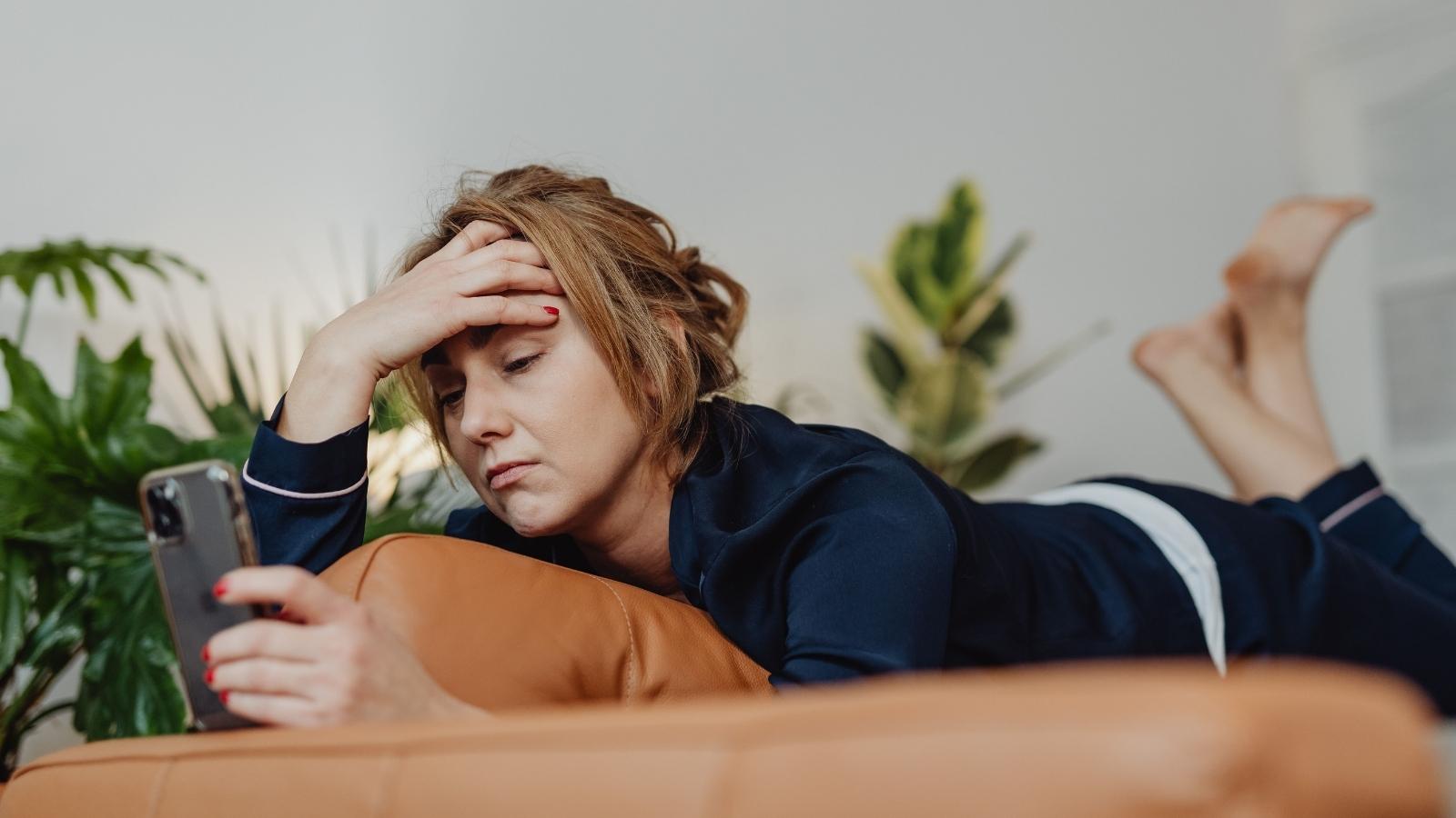 stressed woman lounging on her couch