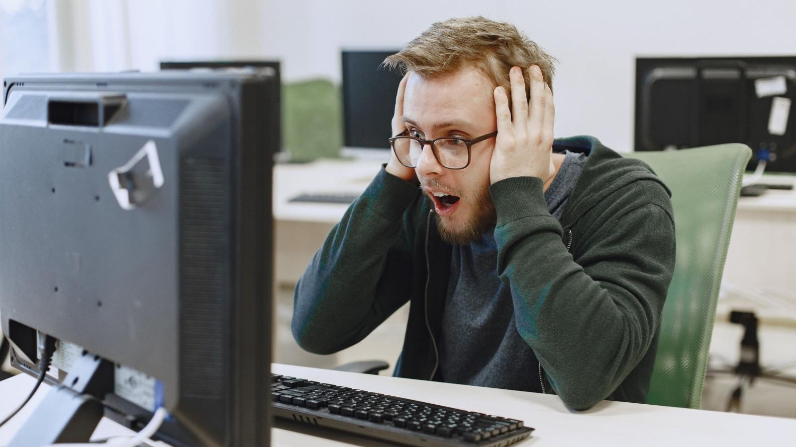 He Stumbled Into Payroll Files By Mistake, Then Found Out Just How Little He Was Actually Being Paid surprised man at computer