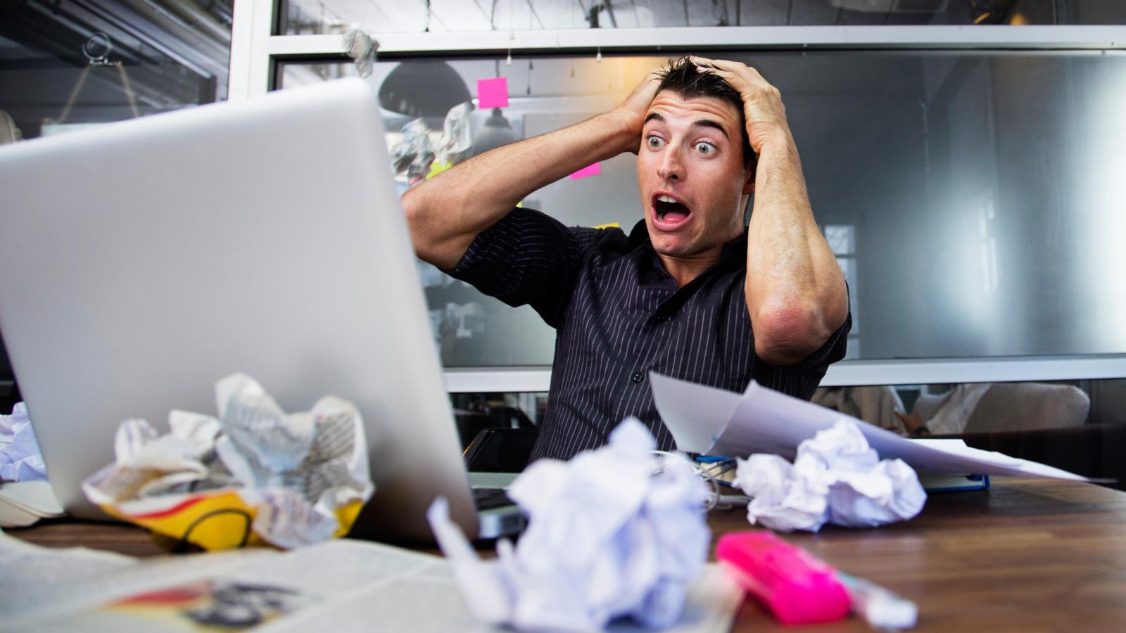 man stressed out at his desk
