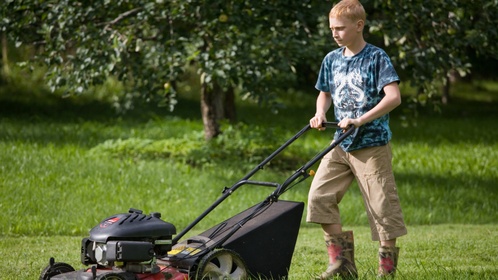 A Homeowner Demanded Her Wet Grass Be Mowed After Being Explicitly Warned—Now Her Ruined Lawn Is an Eyesore for the Whole Neighborhood teen boy mowing lawn in tall boots