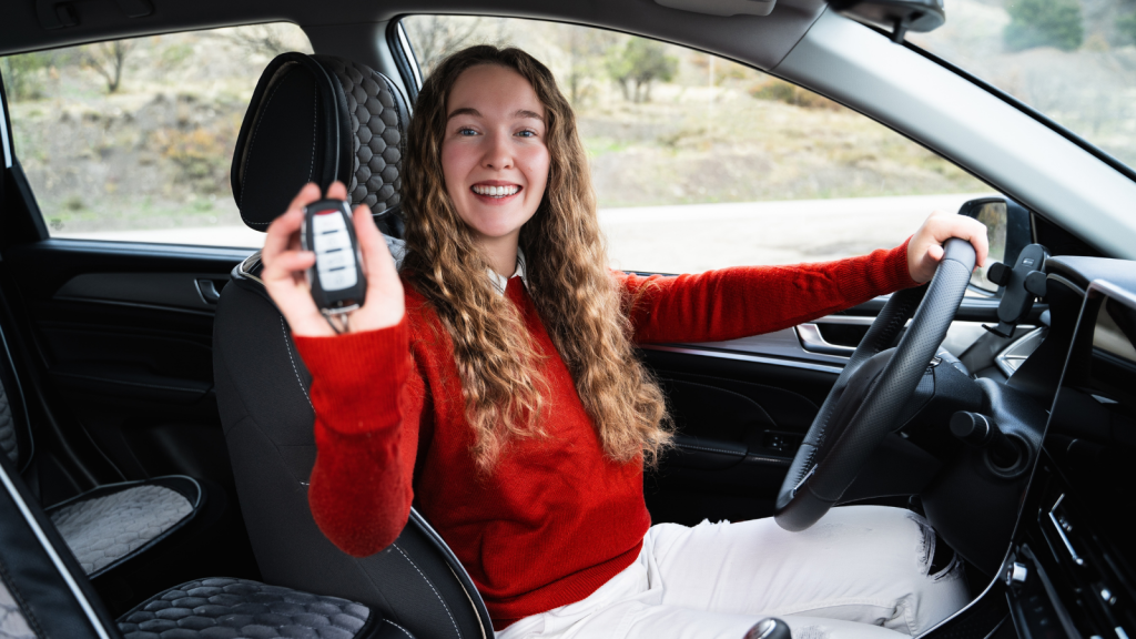 teen girl excited with new car holding keys