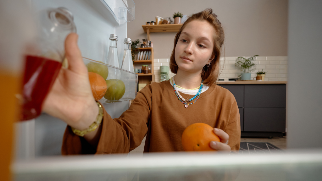 Health Conscious Teen Bought A Mini Fridge To Protect Her Meal Prep, But Her Parents Accused Her Of Hoarding Food From The Family teen girl reaching into mini fridge