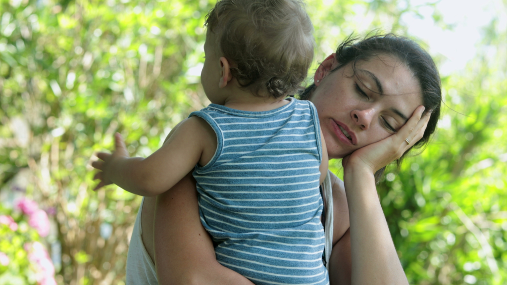 She Hoped Giving Her Husband A Taste Of Her Daily Routine Would Help Him Understand, But He Still Doesn’t See Why She Feels Overwhelmed tired and exhausted mom holding her child