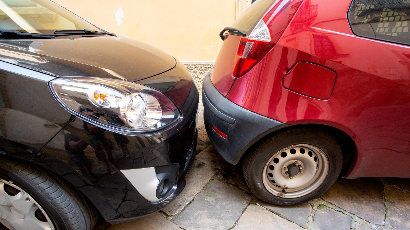 Someone Parked in His Assigned Spot — So He and His Friends Jacked the Car Up and Moved It two cars parked close to each other