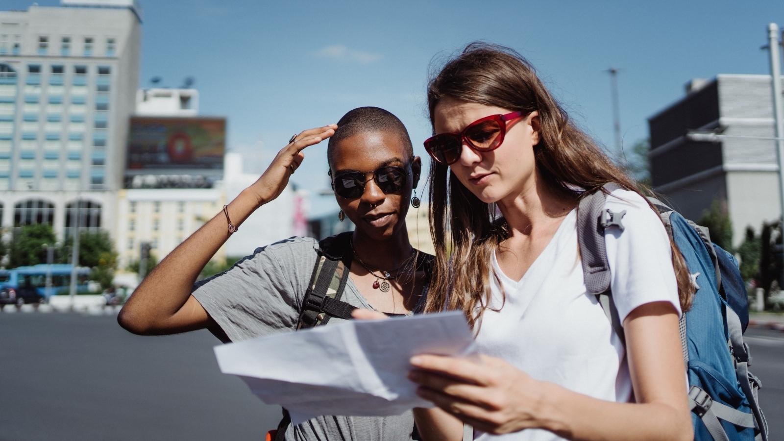 Two Friends Bailed On Her Cottage Trip Without Warning — Then A Penalty Fee Vote Split The Whole Group traveling friends looking at a map