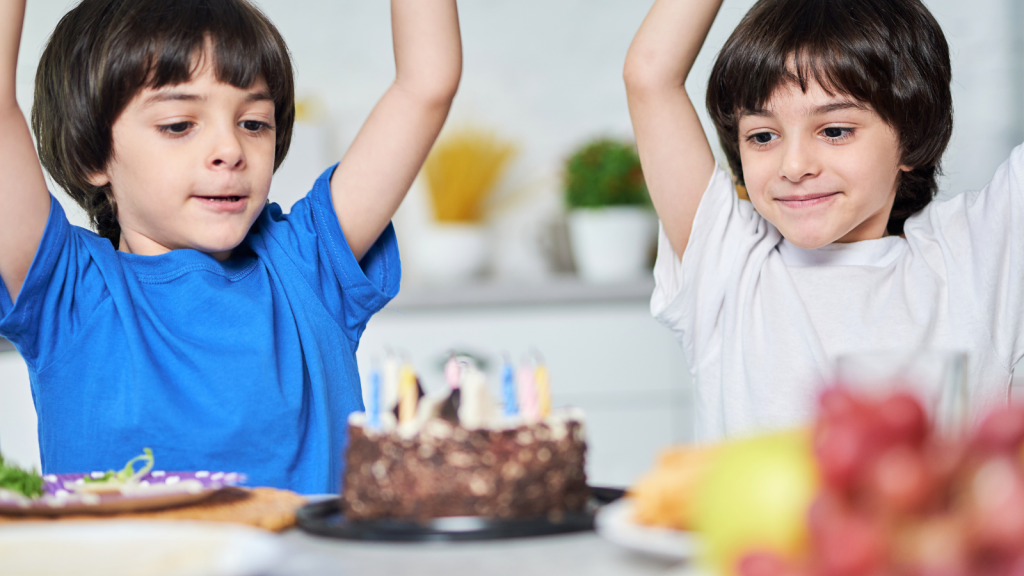 Two Kids Were Added to the Birthday Party at the Last Minute—Now Their Brother Says They Shouldn’t Get Loot Bags twin boys excited birthday cake