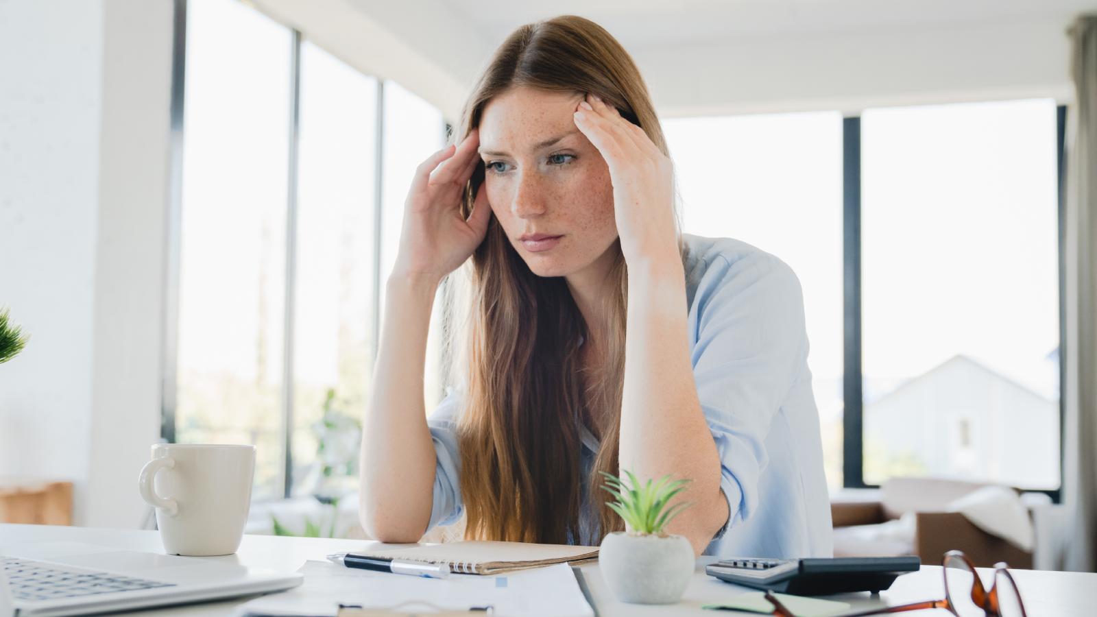 She Finally Landed A Job After Years Of Rejection — But It Left Her Feeling Depressed, Not Fulfilled woman sitting at a desk