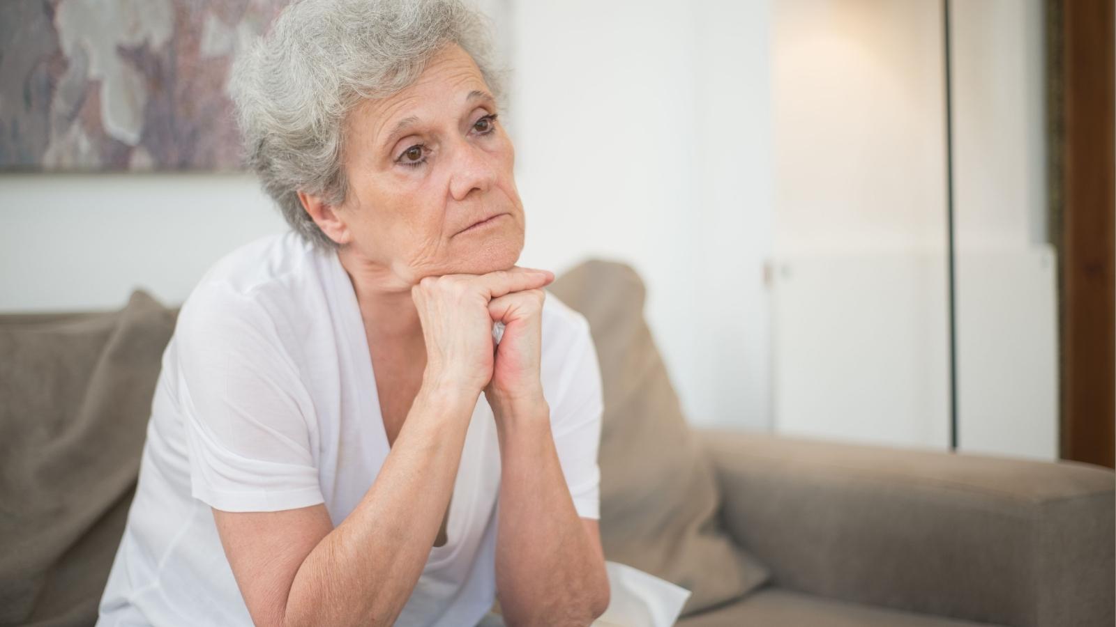 Woman Worried Her Two Bedroom House Couldnt Handle Her Daughters Family And Five Animals With Health Issues upset older woman sitting on the couch