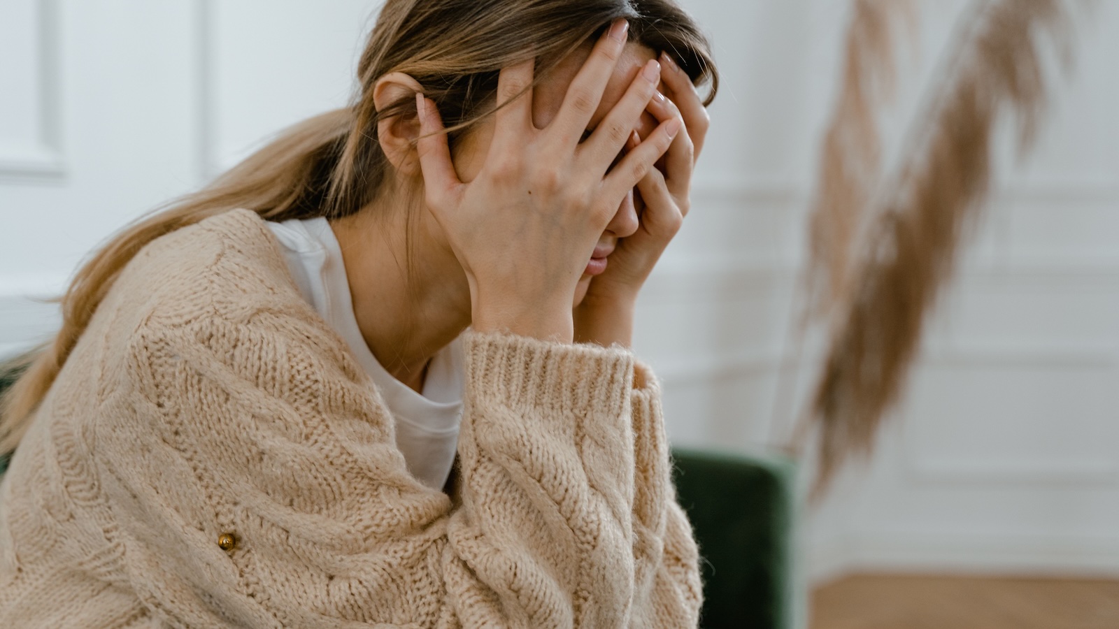 She Was Disowned for Calling 911 on Her Violent Brother—Ten Years Later, Her Estranged Mother Demanded She Take Him In woman with head in hands, upset