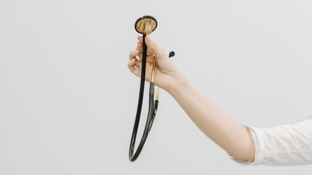 woman holding out a stethoscope