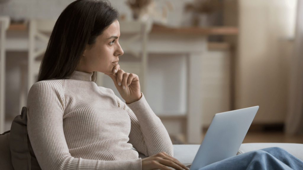 She Covered His Rent and Bills for Five Years—Then He Demanded $30,000 for a Cant Lose Investment Scheme woman in deep thought with laptop