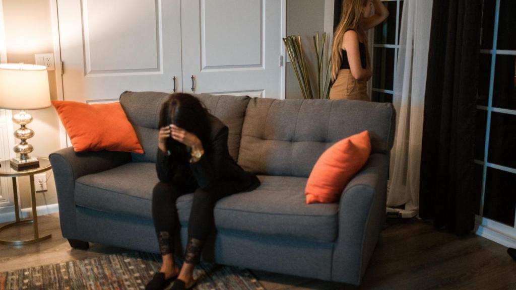 woman looking upset on the couch